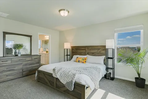 a bedroom with a bed and a potted plant