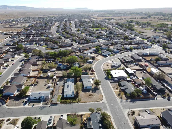 a view of a yard with wooden fence