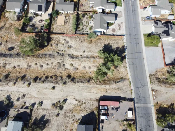 a view of a yard with wooden fence