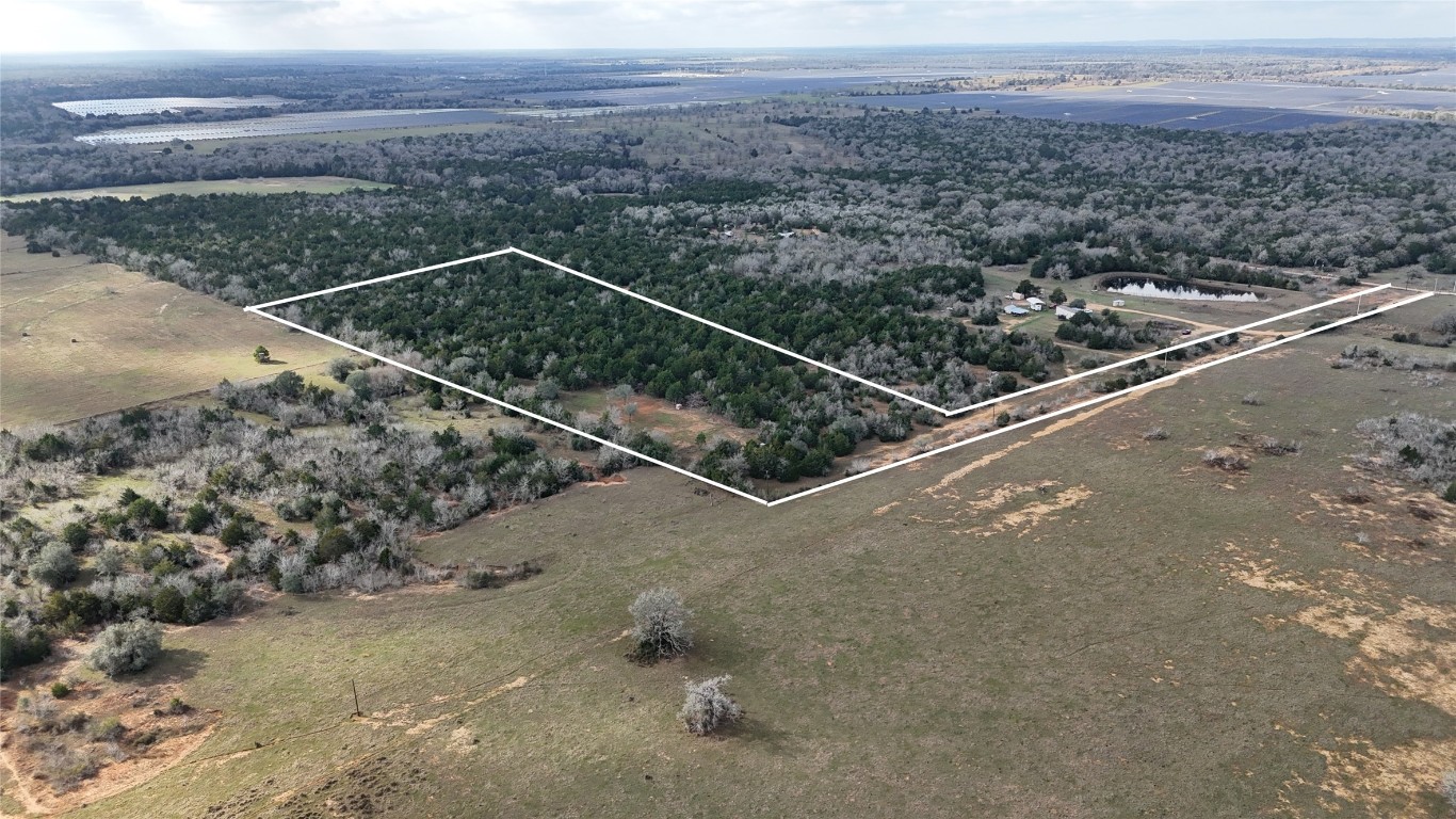 259 Meduna Road Smithville, TX 78957 - Photo 2 of 12 a view of a dry yard with wooden fence
