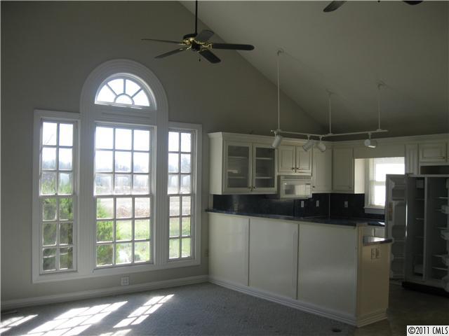 2012 Haigler Baucom Road Monroe, NC 28110 - Photo 3 of 11 a kitchen with stainless steel appliances a large window and a refrigerator