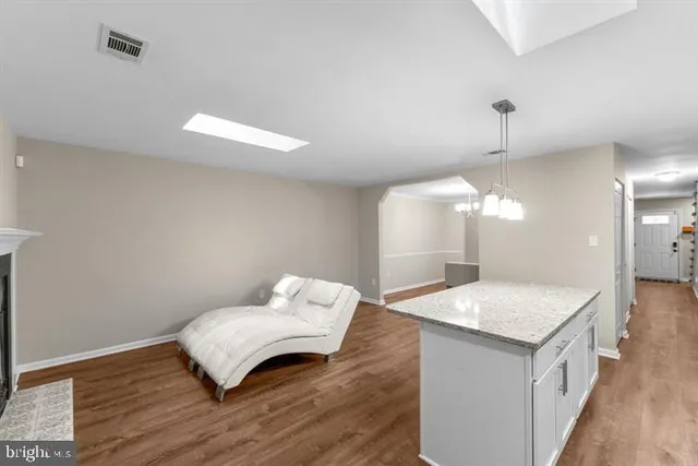 a living room with a sink and chandelier