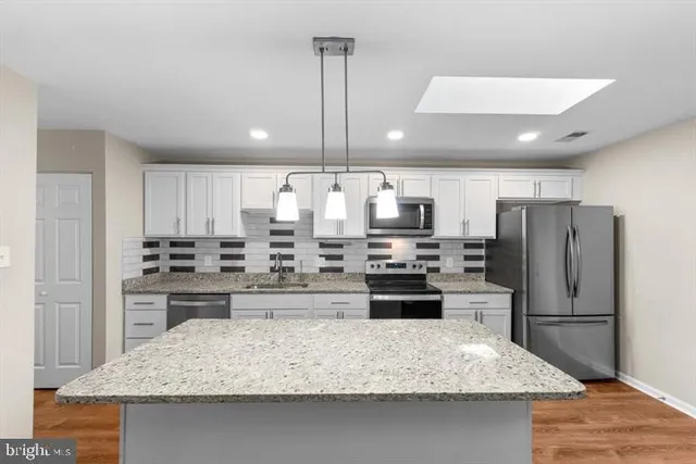 a kitchen with refrigerator and stove