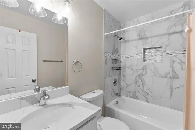 a bathroom with a sink a toilet and a bathtub