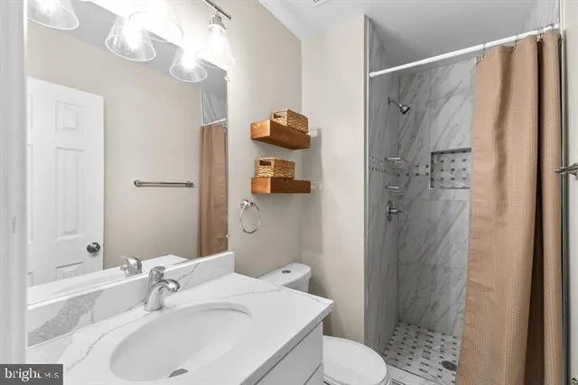 a bathroom with a sink toilet and shower