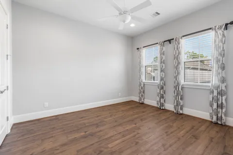 wooden floor in an empty room with a window