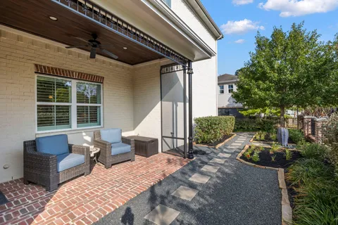 a balcony with furniture and a potted plant