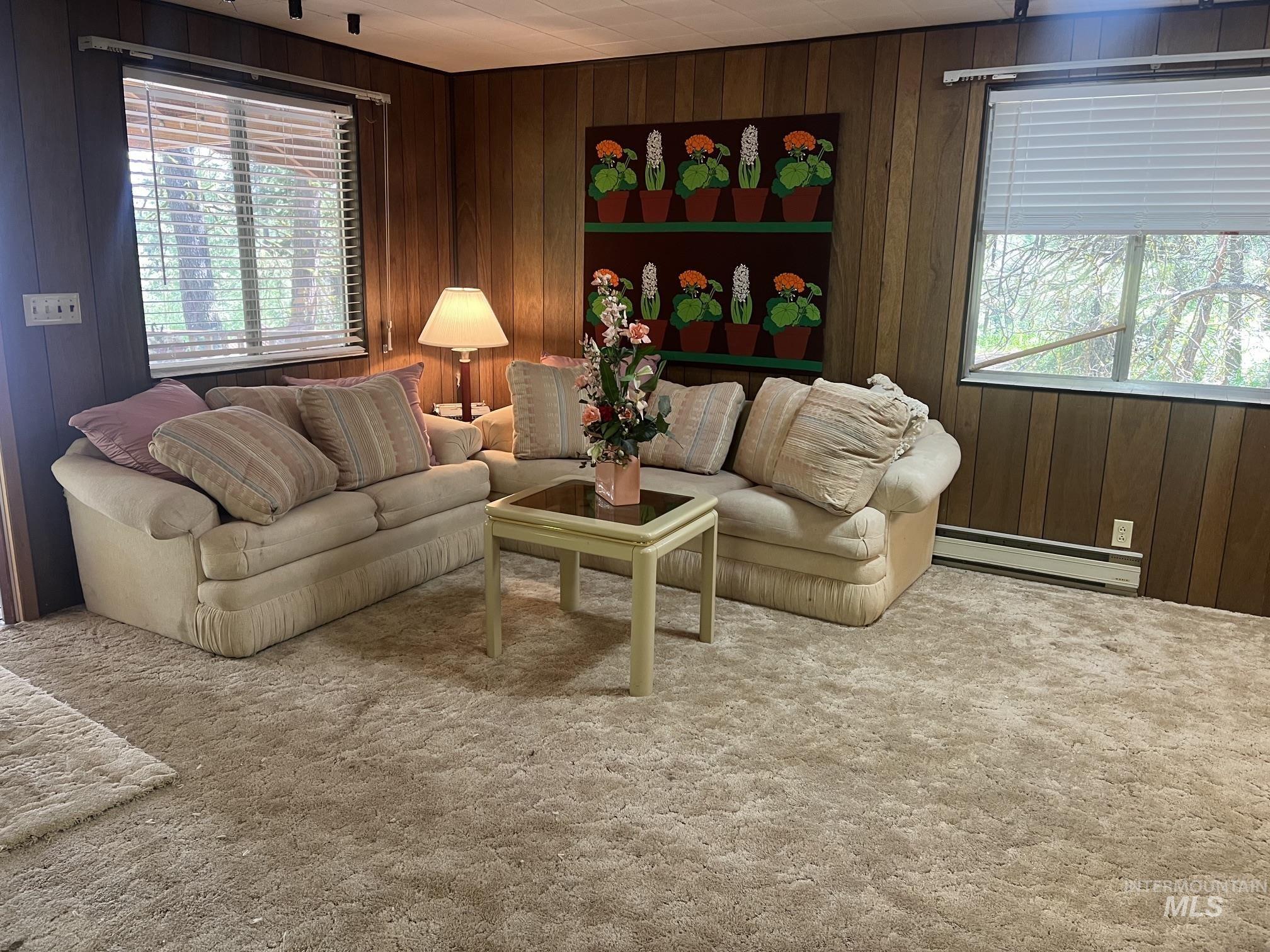 39 Mayflower Mine Road Placerville, ID 83666 - Photo 16 of 36 Carpeted interior space featuring wood-paneled walls and multiple windows