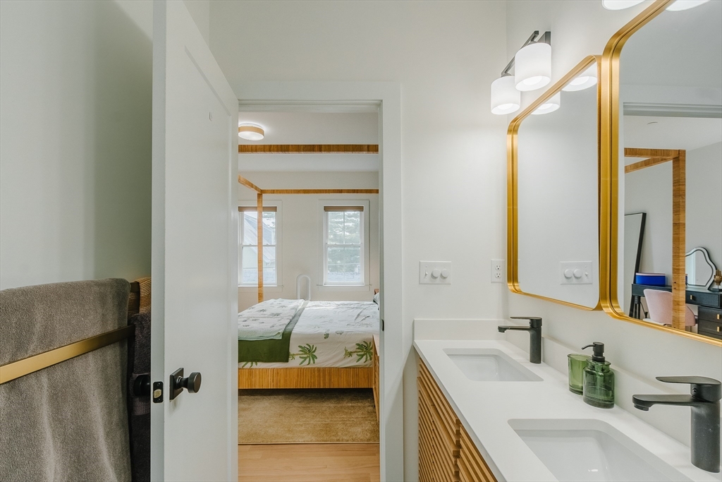 43 Withington Street, Unit 7 Boston, MA 02124 - Photo 16 of 21 a en suite bathroom with a granite countertop sink and a mirror
