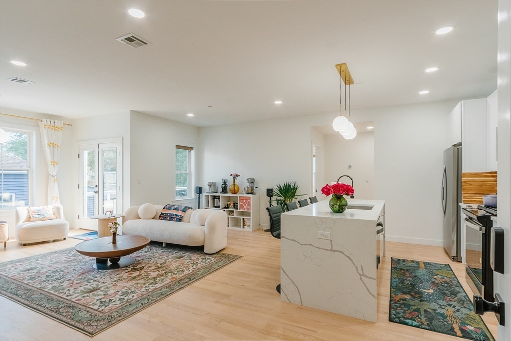 43 Withington Street, Unit 7 Boston, MA 02124 - Photo 2 of 21 a living room with furniture and a wooden floor