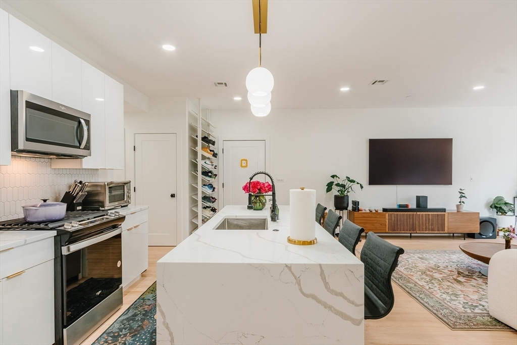 43 Withington Street, Unit 7 Boston, MA 02124 - Photo 3 of 21 a living room with furniture and a flat screen tv