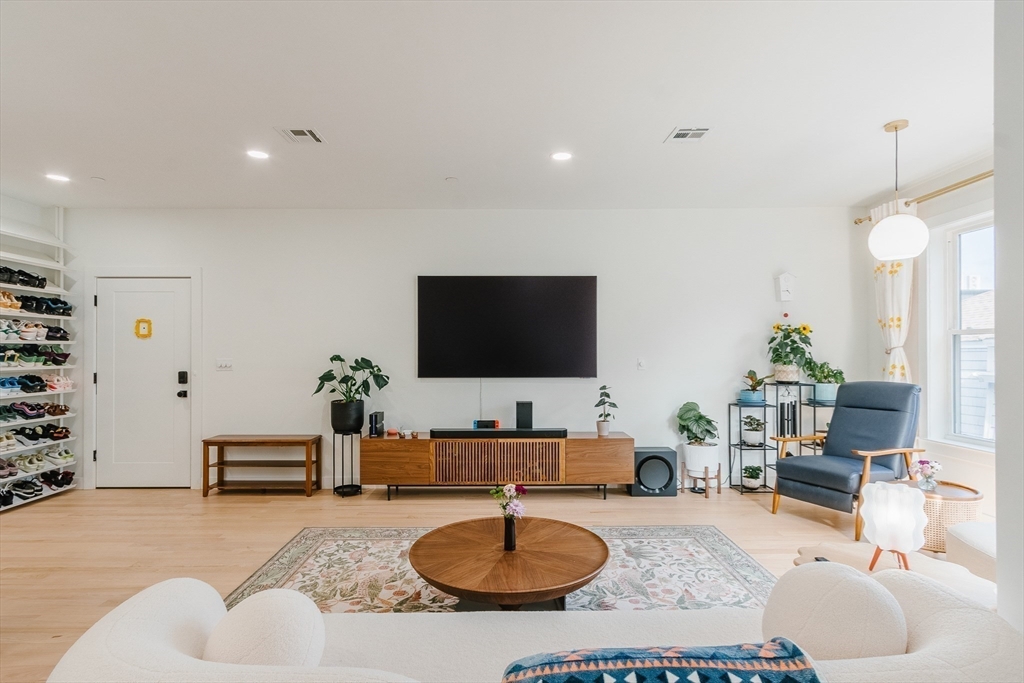 43 Withington Street, Unit 7 Boston, MA 02124 - Photo 5 of 21 a living room with furniture and a flat screen tv