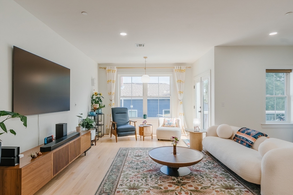 43 Withington Street, Unit 7 Boston, MA 02124 - Photo 6 of 21 a living room with furniture and a flat screen tv
