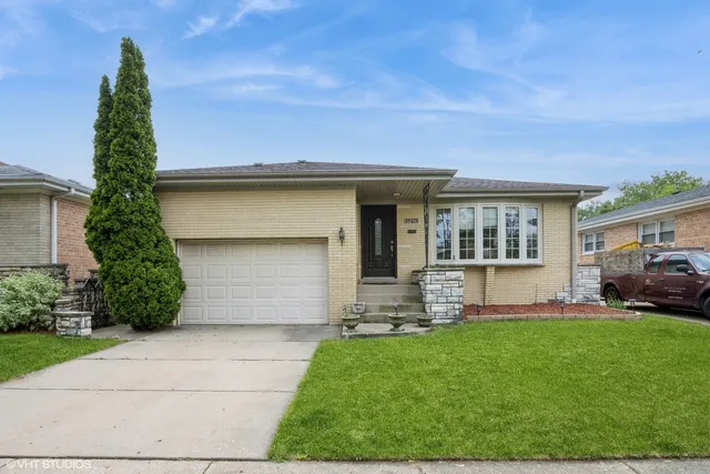 a front view of a house with a yard and garage