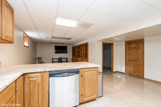 a view of a kitchen with a sink and a refrigerator