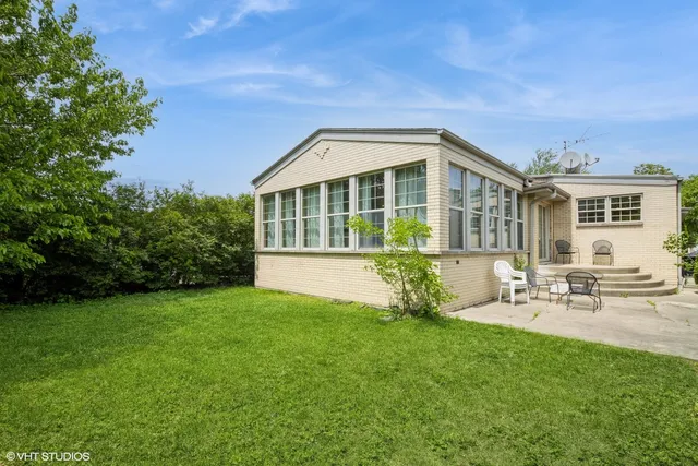 a view of a house with a yard porch and sitting area