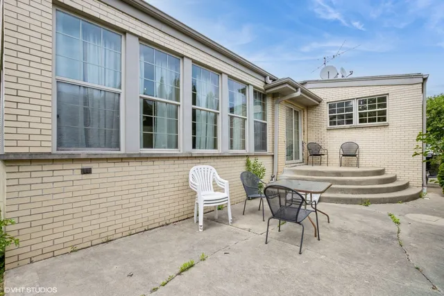a view of backyard with plants and large trees