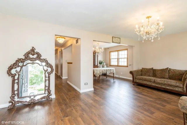 a living room with furniture and a chandelier