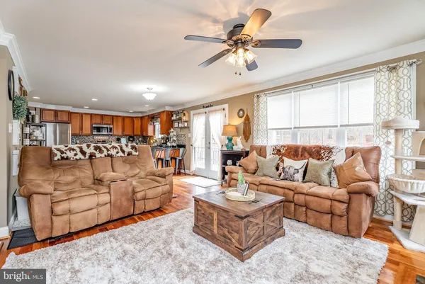 a kitchen with stainless steel appliances granite countertop a refrigerator a stove and a sink