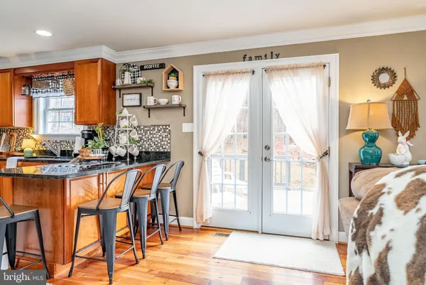 a kitchen with stainless steel appliances granite countertop a refrigerator stove and sink