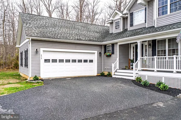 a view of a house with a yard and garage