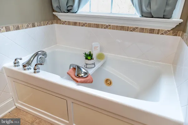 a view of livingroom with bookshelf and wooden floor