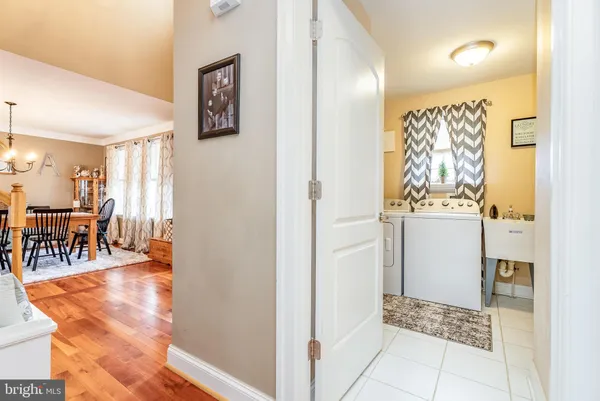 a bedroom with a bed a chair and a chandelier