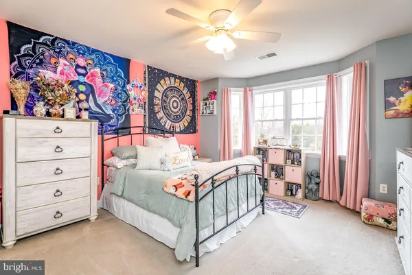 a bathroom with a sink a toilet and a large mirror