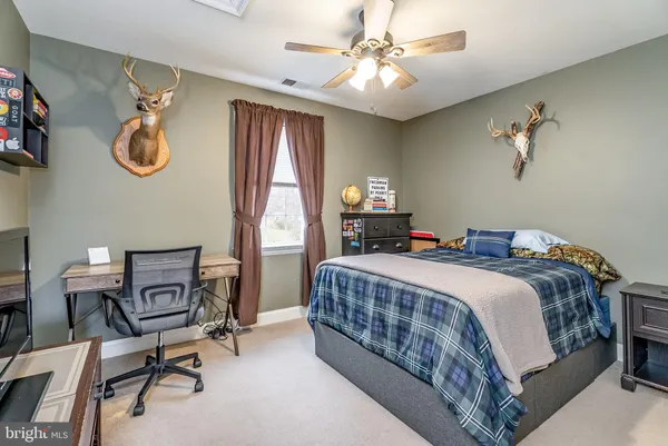 a view of a house with a yard patio and fire pit