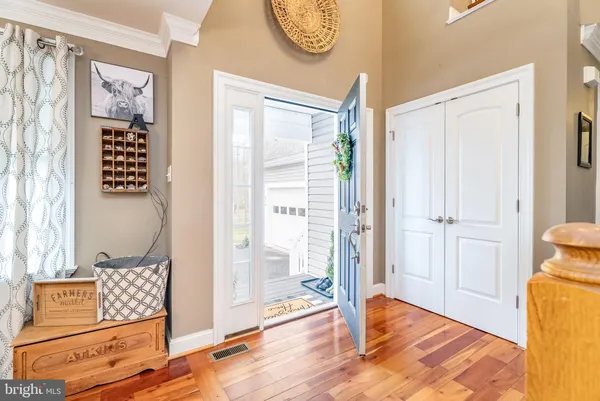 a dining room with furniture a chandelier and wooden floor