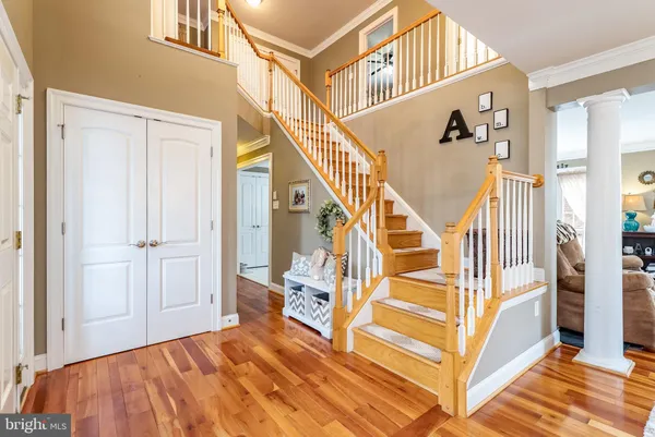 a dining room with furniture a chandelier and wooden floor