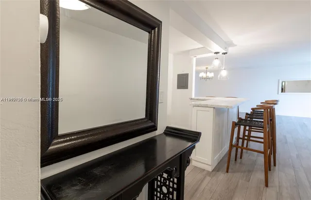 a view of a hallway with furniture and wooden floor