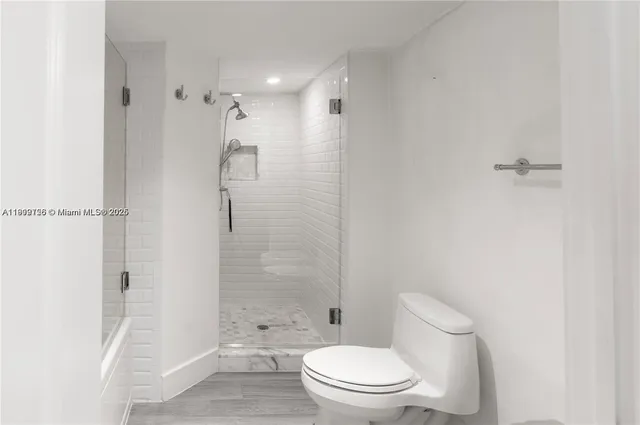 a bathroom with a toilet and shower