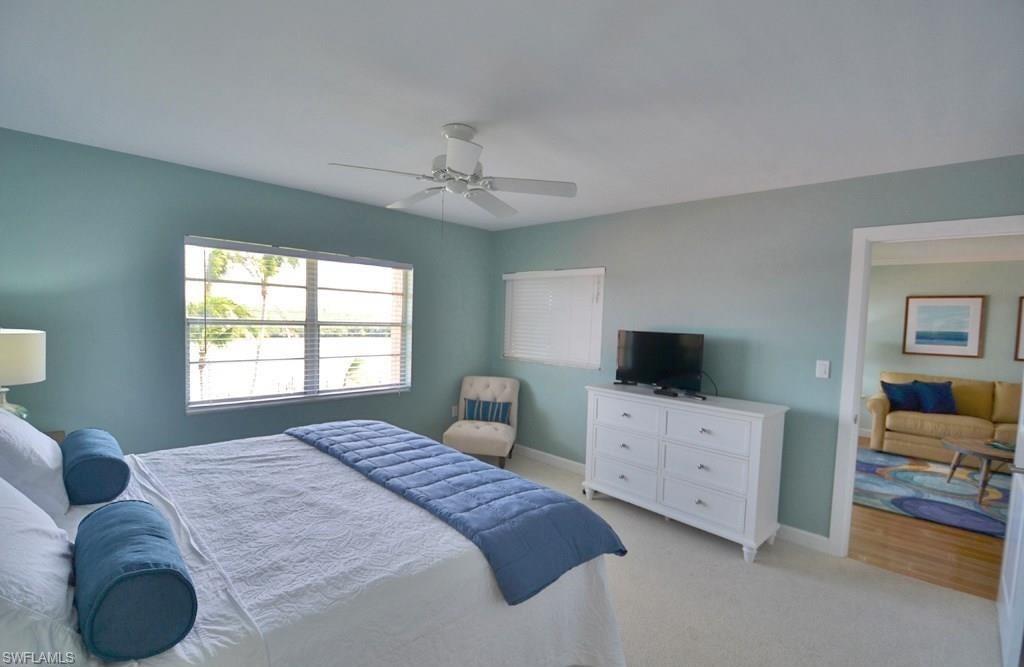 307 Goodlette-Frank Road, Unit 506B Naples, FL 34102 - Photo 13 of 25 a bedroom with a bed and a television