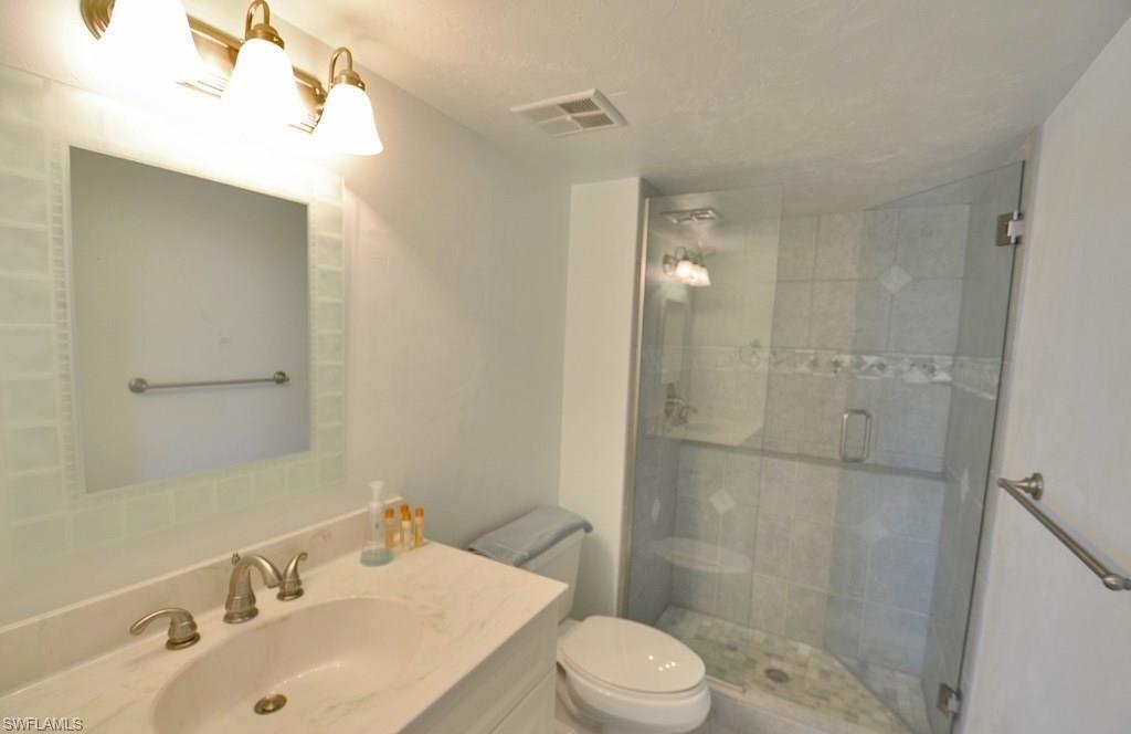 307 Goodlette-Frank Road, Unit 506B Naples, FL 34102 - Photo 14 of 25 a bathroom with a sink toilet and shower