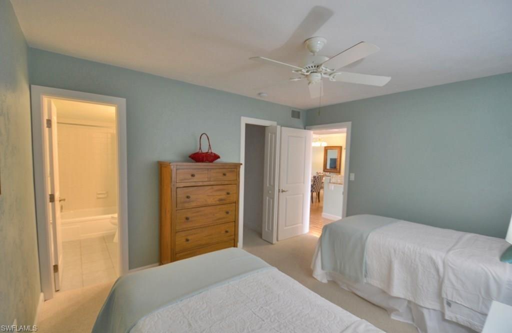 307 Goodlette-Frank Road, Unit 506B Naples, FL 34102 - Photo 16 of 25 a bedroom with a bed and a dresser