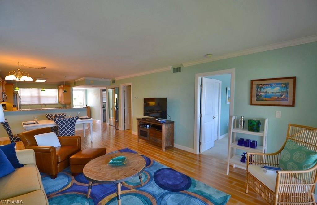 307 Goodlette-Frank Road, Unit 506B Naples, FL 34102 - Photo 3 of 25 a living room with furniture and a flat screen tv