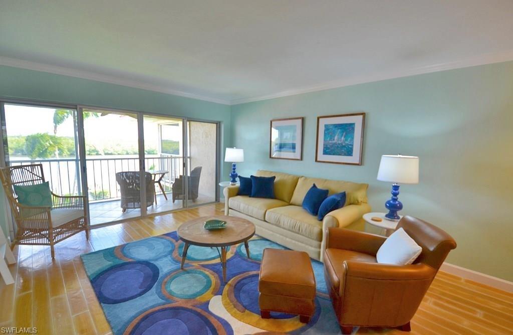 307 Goodlette-Frank Road, Unit 506B Naples, FL 34102 - Photo 4 of 25 a living room with furniture and a large window
