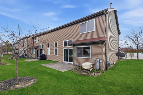 a view of a house with a backyard
