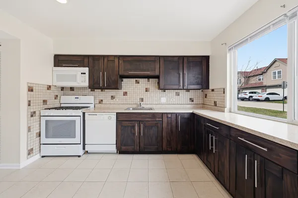 a kitchen with a sink a stove and cabinets
