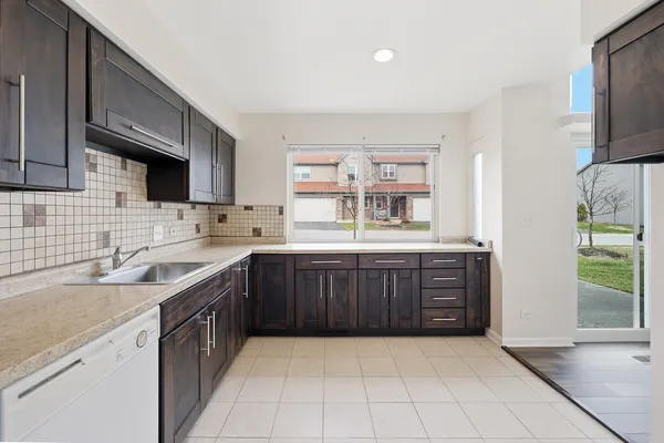 a kitchen with a sink stove and microwave