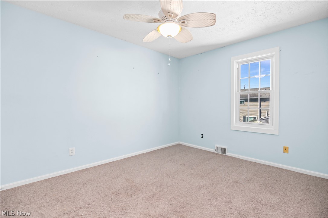 44 Center Road Vermilion, OH 44089 - Photo 23 of 38 Unfurnished room with light carpet and ceiling fan