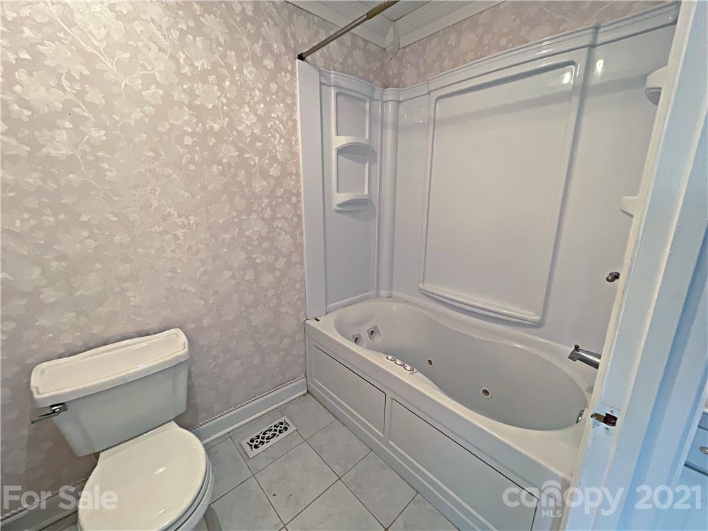 2641 Elbow Road Newton, NC 28658 - Photo 14 of 31 a white toilet sitting next to a bath tub