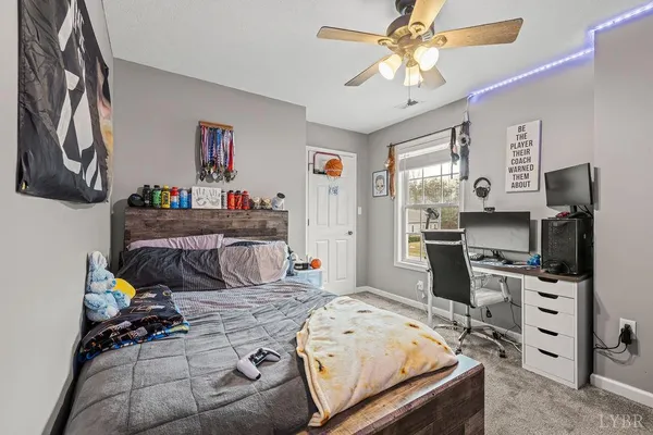 a spacious bedroom with a bed and a chandelier