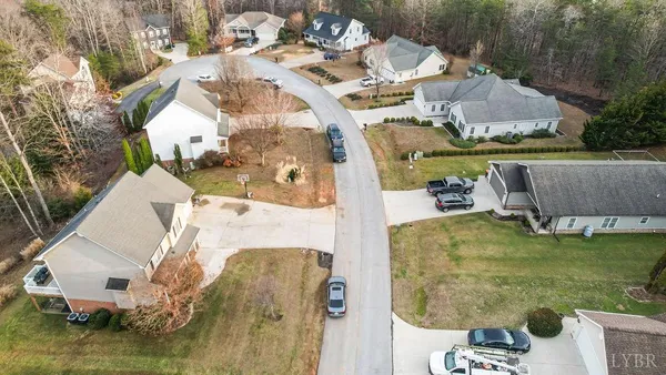 a aerial view of a house with a yard table and chairs
