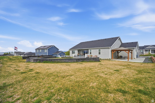 638 Canyon Rim Road Smithfield, UT 84335 - Photo 46 of 56 Rear view of property featuring a patio, a gazebo, a lawn, and a residential view
