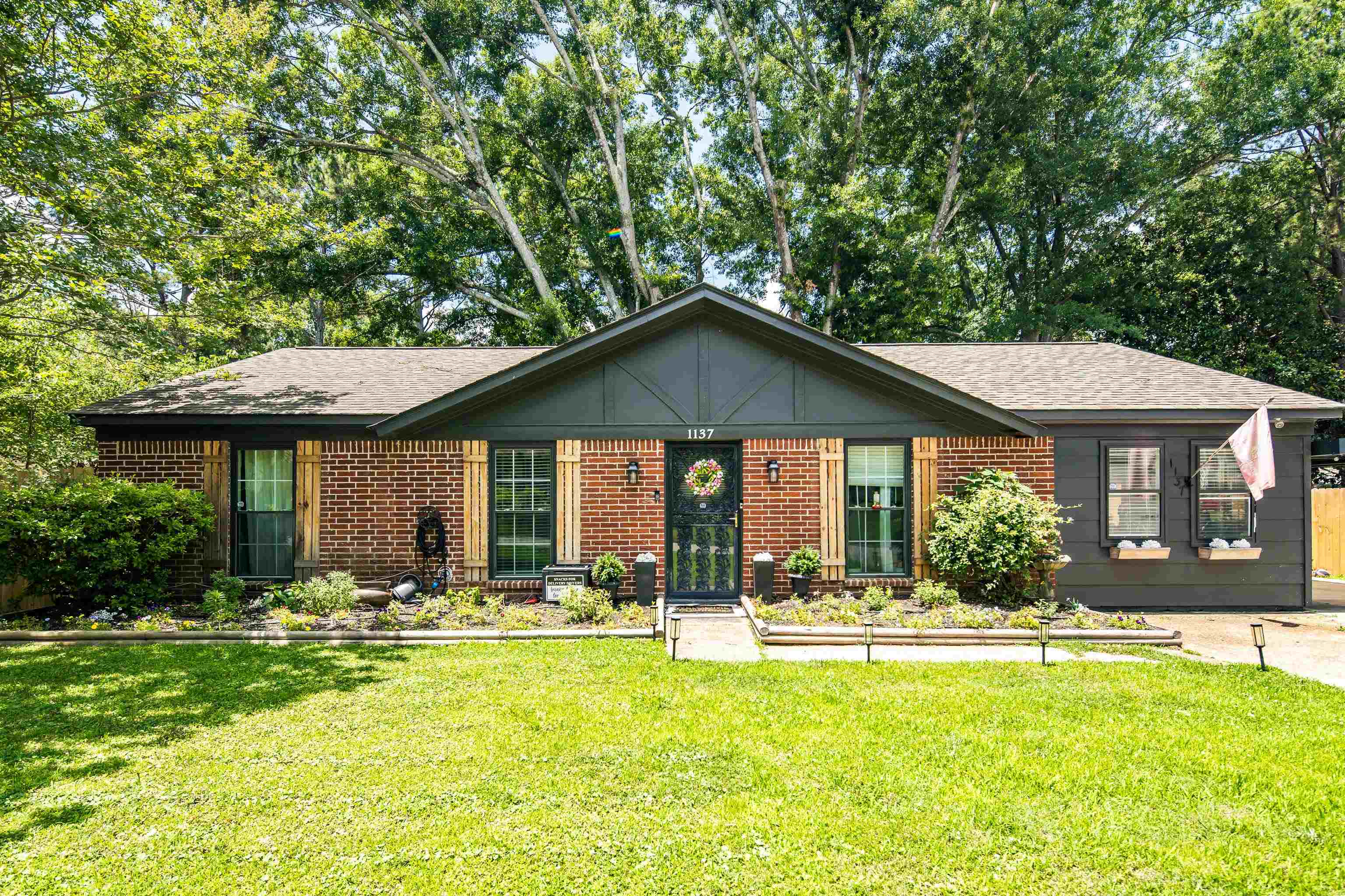 1137 Greenview Road Collierville, TN 38017 - Photo 1 of 35 a backyard of a house with table and chairs