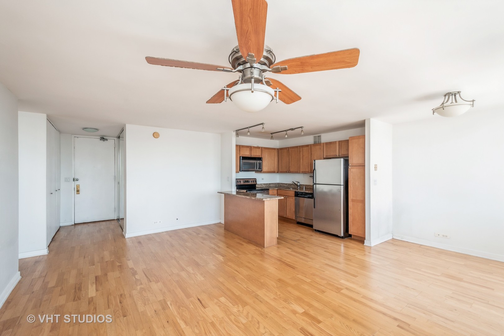 655 West Irving Park Road, Unit 4915 Chicago, IL 60613 - Photo 5 of 17 a view of a kitchen with a sink and a refrigerator