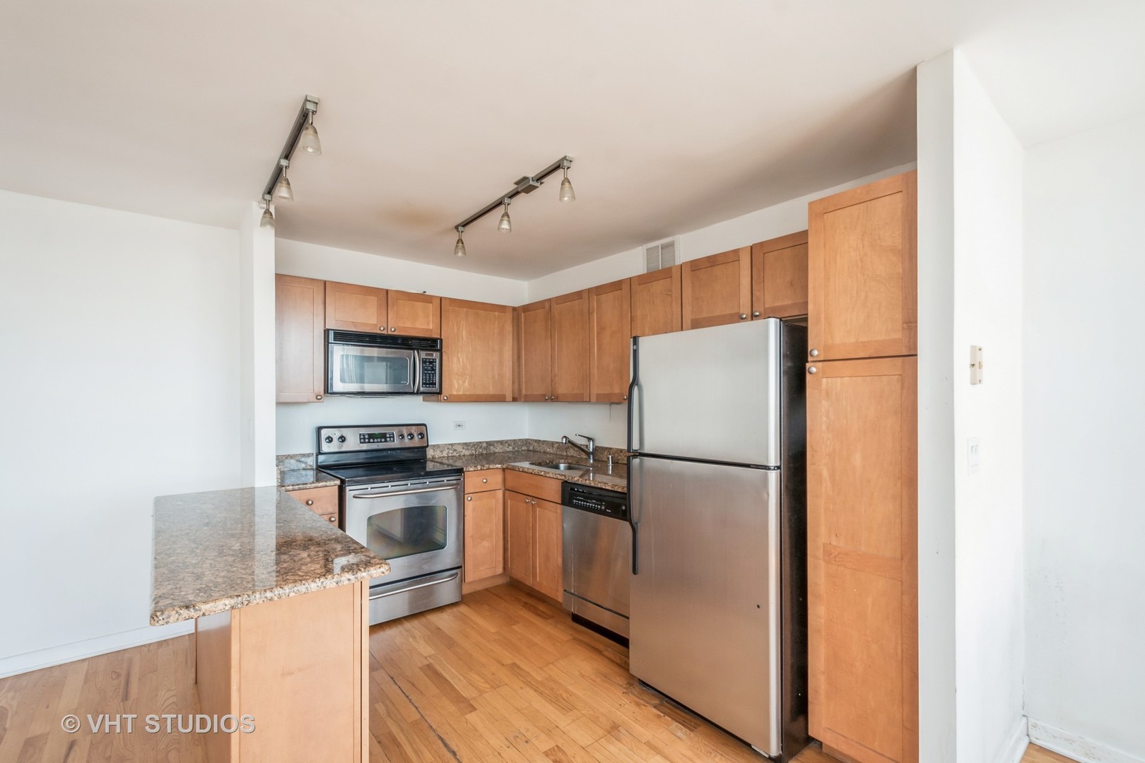 655 West Irving Park Road, Unit 4915 Chicago, IL 60613 - Photo 8 of 17 a kitchen with stainless steel appliances granite countertop a refrigerator a stove a sink dishwasher and a refrigerator with wooden floor
