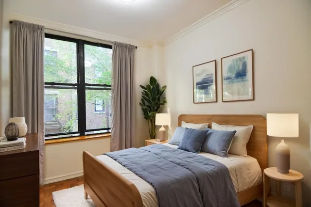 a bedroom with a balcony a bed and a painting on the wall